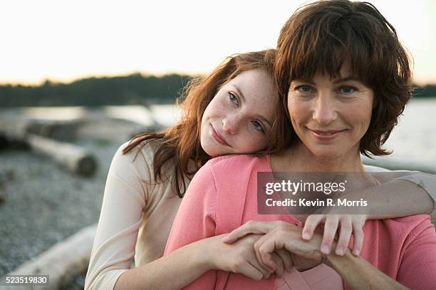 mother and daughter on beach at dusk - young teen girl beach foto e immagini stock