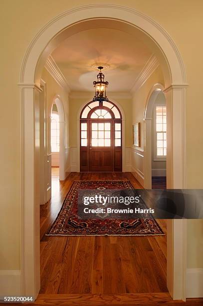 hallway leading to front door - arch stock pictures, royalty-free photos & images