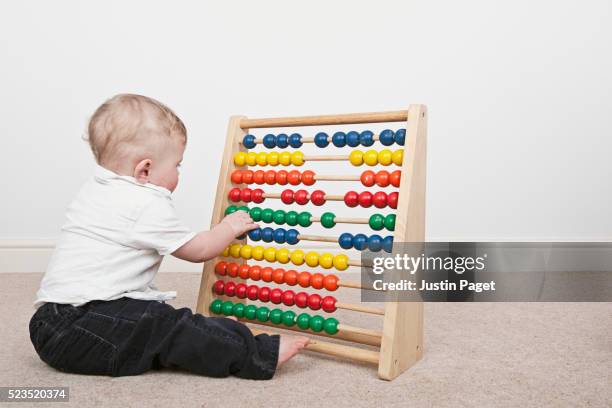 baby boy with abacus - abacus stock pictures, royalty-free photos & images