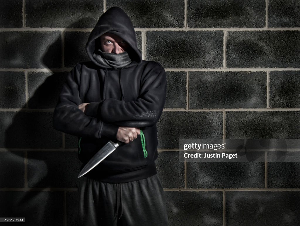 Intimidating Hooded Male Clutching Knife