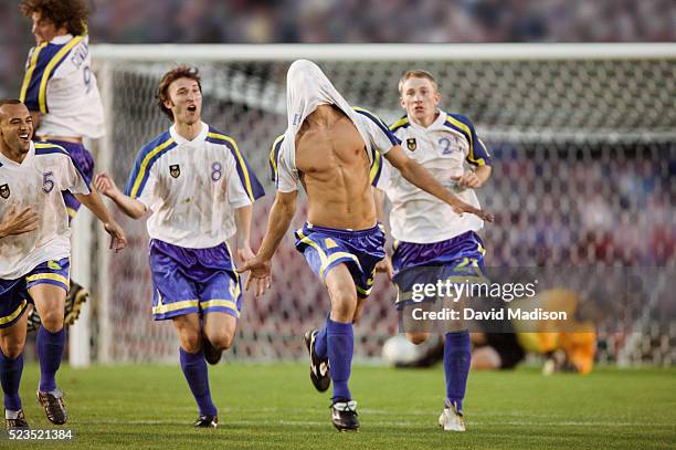 soccer team celebrating goal - scoring goal stock pictures, royalty-free photos & images