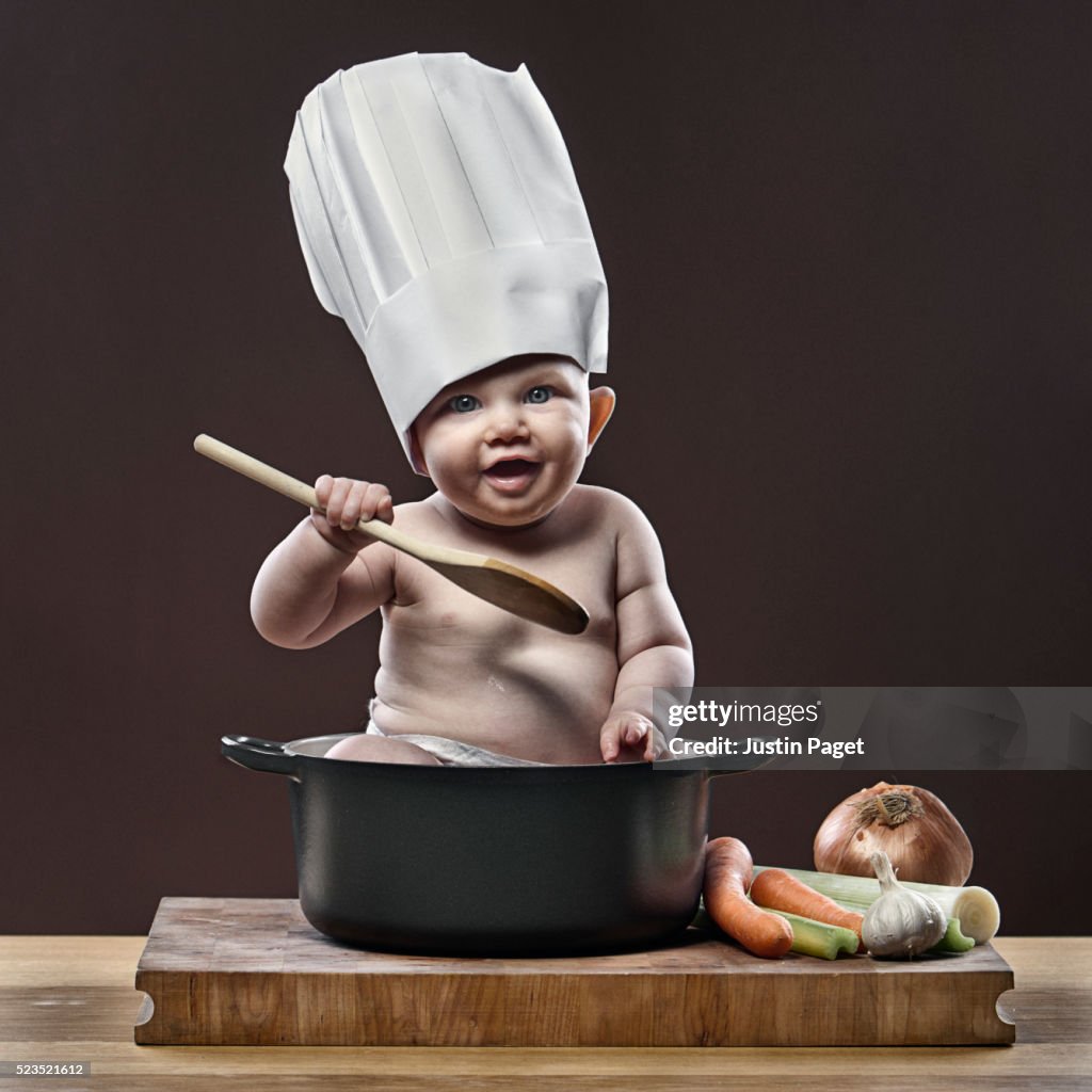 Baby girl (1-6 months) cooking in pot