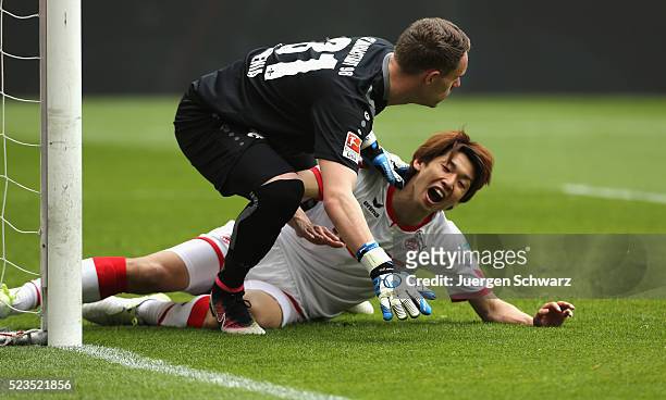 Goalkeeper Christian Mathenia of Darmstadt falls over Yuya Osako of Cologne during the Bundesliga match between 1. FC Koeln and SV Darmstadt 98 at...