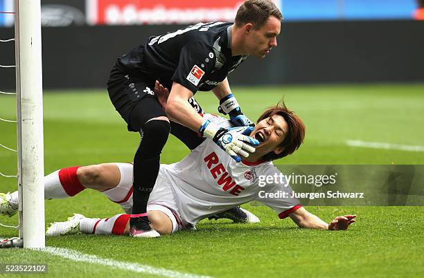 Goalkeeper Christian Mathenia of Darmstadt falls over Yuya Osako of Cologne during the Bundesliga match between 1. FC Koeln and SV Darmstadt 98 at...