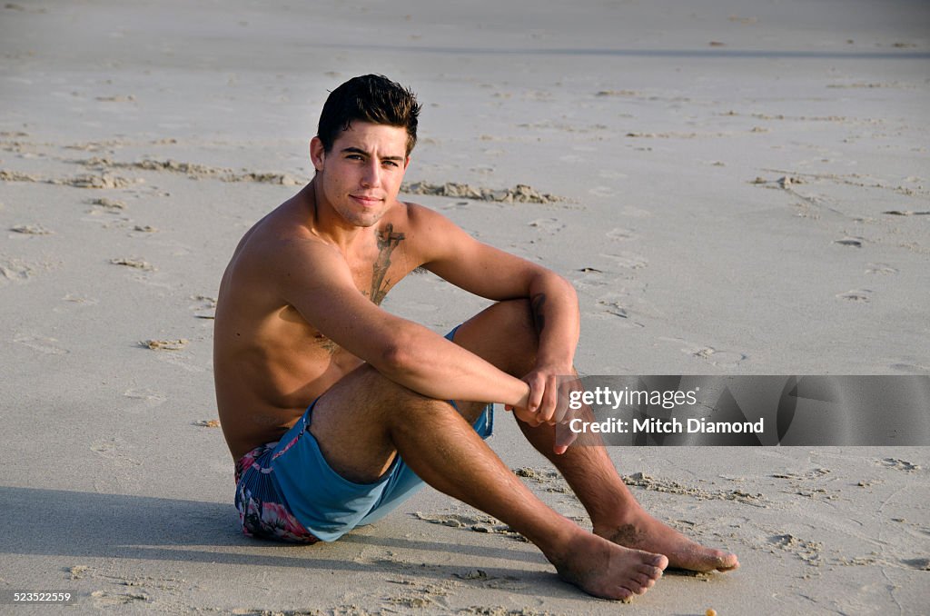 Young man sitting at the beach