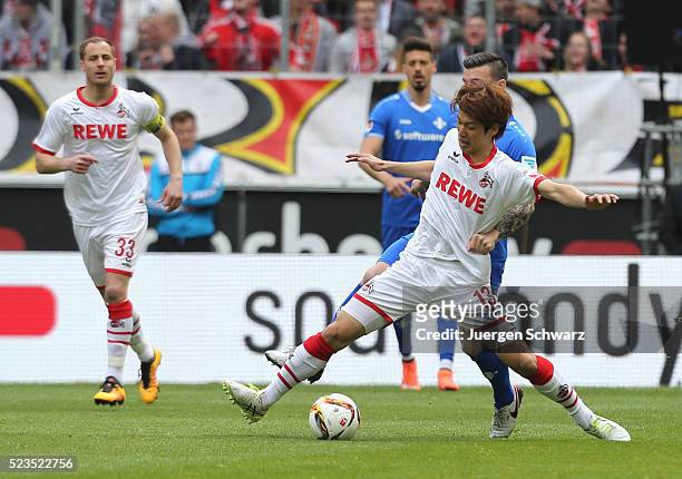 Yuya Osako of Cologne and Jerome Gondorf of Darmstadt battle for the ball during the Bundesliga match between 1. FC Koeln and SV Darmstadt 98 at...
