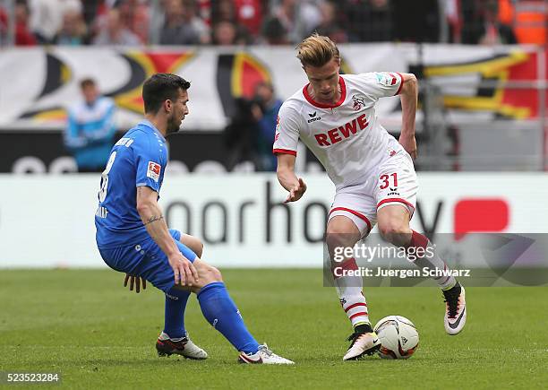 Yannick Gerhardt of Cologne tackles Jerome Gondorf of Darmstadt during the Bundesliga match between 1. FC Koeln and SV Darmstadt 98 at...