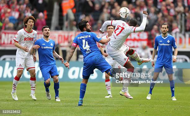 Anthony Modeste of Cologne and Aytac Sulu of Darmstadt jump for the ball during the Bundesliga match between 1. FC Koeln and SV Darmstadt 98 at...