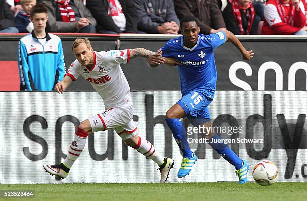 Marcel Risse of Cologne and Junior Diaz of Darmstadt fight for the ball during the Bundesliga match between 1. FC Koeln and SV Darmstadt 98 at...