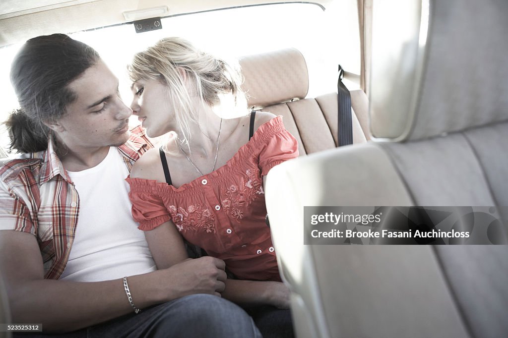 Couple kissing in a car