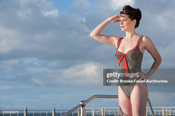 woman in vintage swimsuit standing on side of pool - vintage 1950s woman stock pictures, royalty-free photos & images