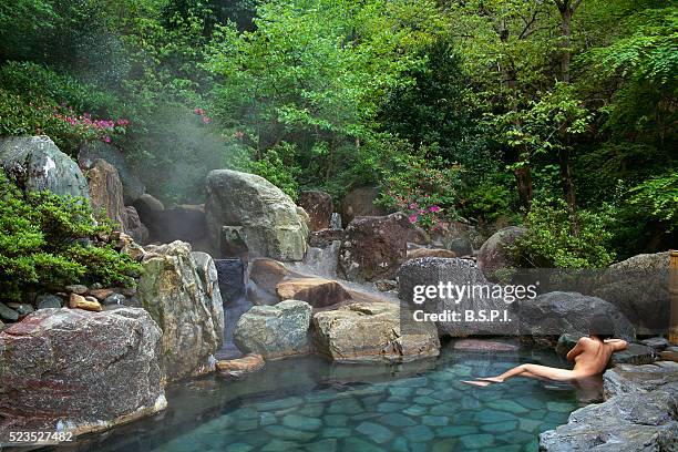 relaxing in a hot spring bath - onsen japan stock pictures, royalty-free photos & images