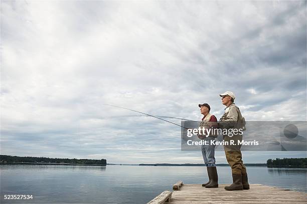 men fly-fishing at sebago lake - pescatore foto e immagini stock