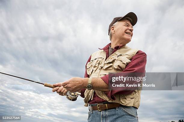 man fly-fishing at sebago lake - fly fishing fotografías e imágenes de stock