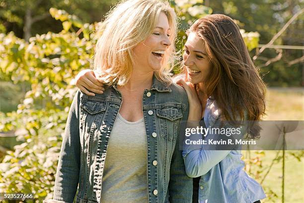 mother and daughter laughing - mature woman daughter stock pictures, royalty-free photos & images