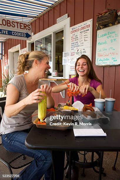 mother and daughter at seafood restaurant - teenagers eating with mum stock pictures, royalty-free photos & images
