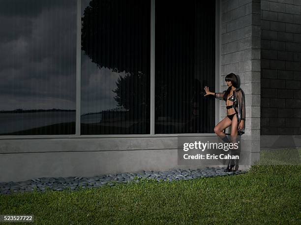 young woman in lingerie leaning against a building - street walker stock pictures, royalty-free photos & images