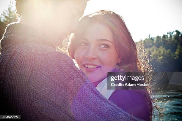 couple embracing in sunlight - couple warm stock-fotos und bilder