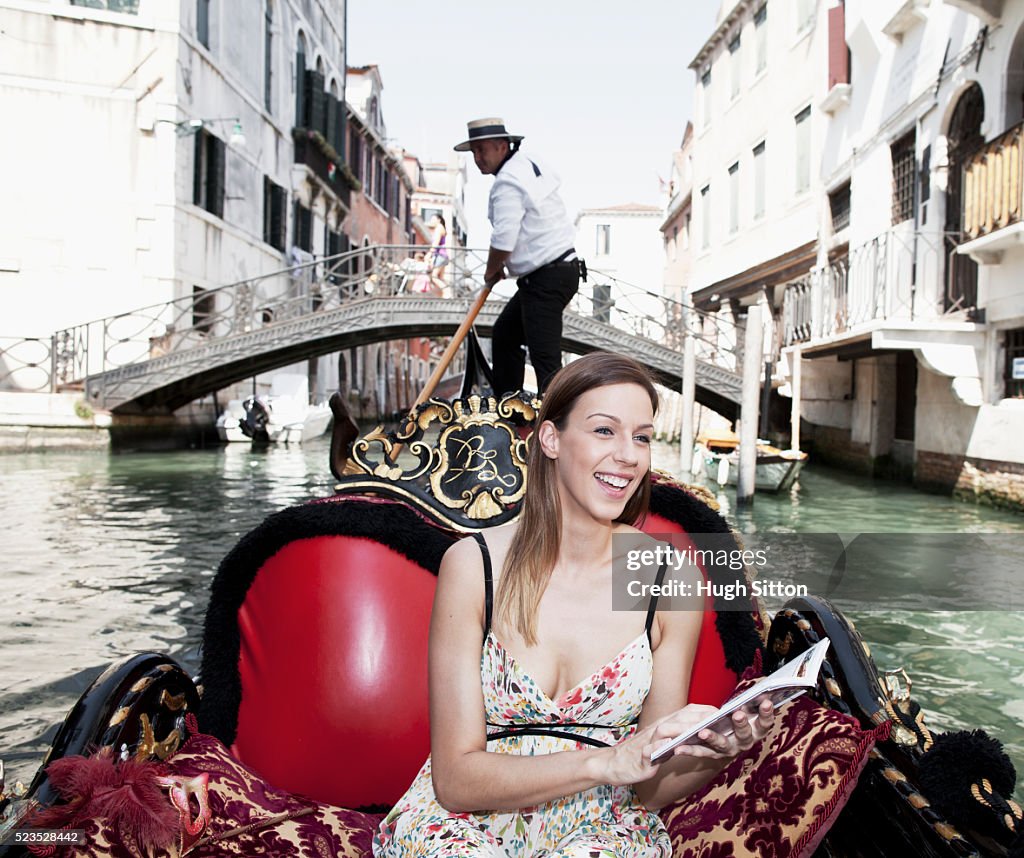 Female tourist in gondola , Venice, Italy
