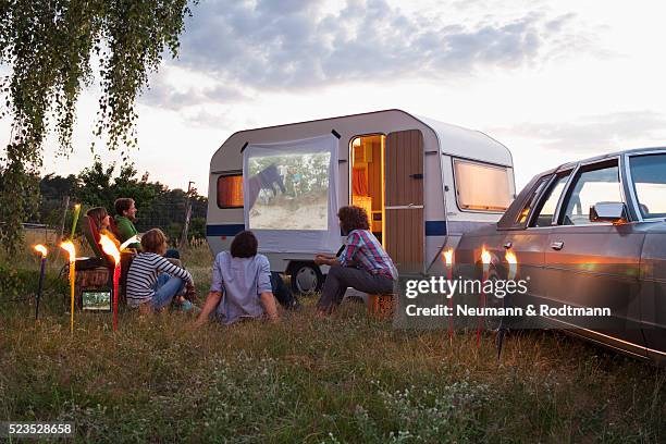 friends watching movie on projection screen at camping site - archival camping stock pictures, royalty-free photos & images