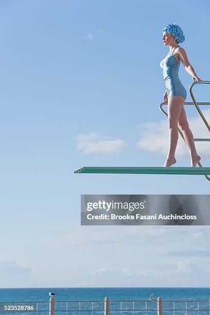 young woman on a high dive - diving board stock pictures, royalty-free photos & images