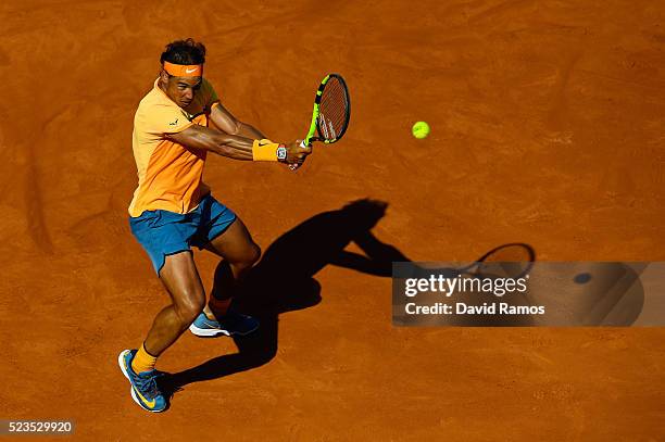 Rafael Nadal of Spain plays a backhand against Philipp Kohlschreiber of Germany during day six of the Barcelona Open Banc Sabadell at the Real Club...