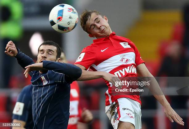 Aleksandr Zuyev of FC Spartak Moscow challenged by Aslan Dudiyev of FC Mordovia Saransk during the Russian Premier League match between FC Spartak...