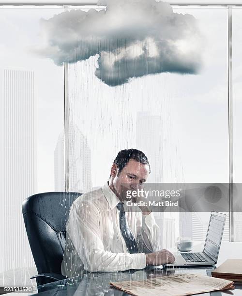 rain falling on sad business man sitting at desk in office - wet bird stock-fotos und bilder