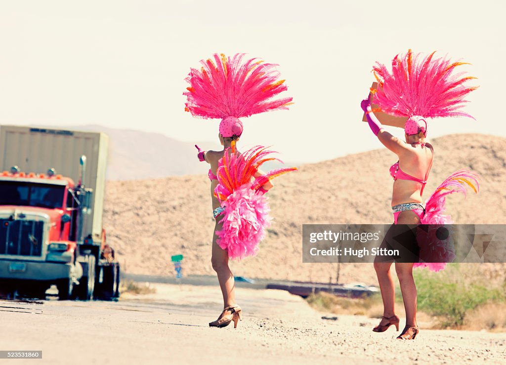 Showgirls hitchhiking