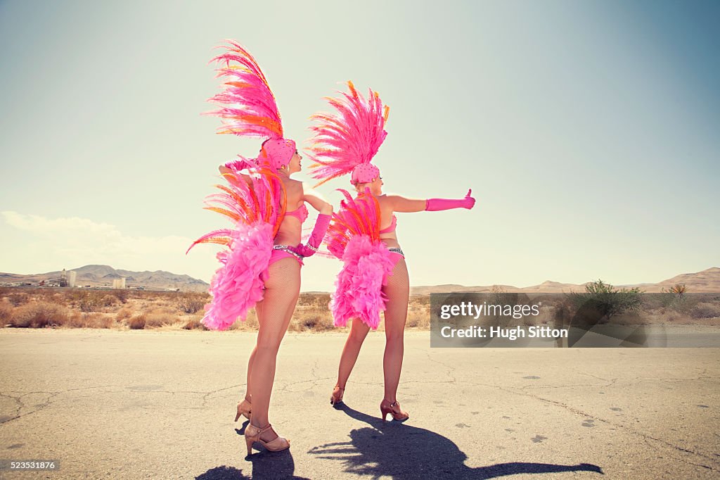 Showgirls hitchhiking