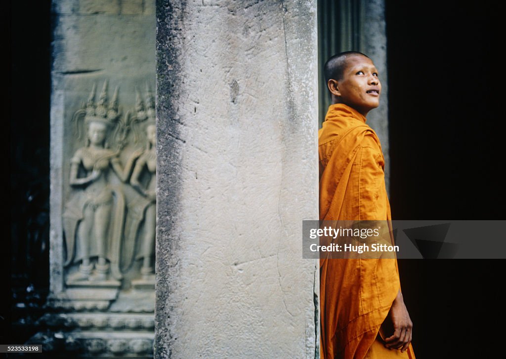 Buddhist Monk Against Column