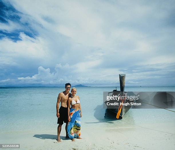 young couple at beach - hugh sitton stock-fotos und bilder