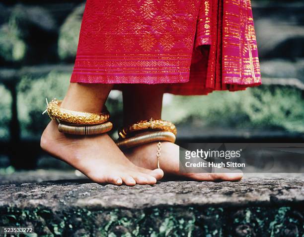 young buddhist woman wearing gold anklets - hugh sitton stock pictures, royalty-free photos & images
