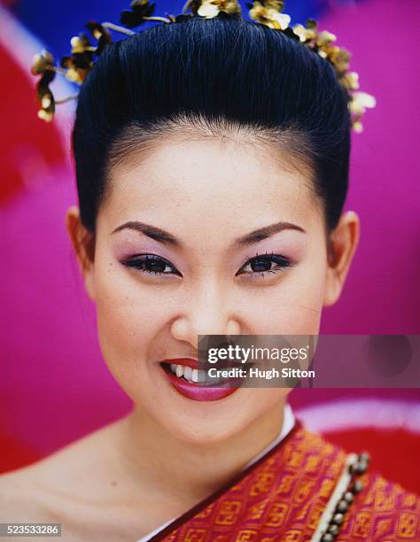 smiling thai woman wearing traditional dress - hugh sitton stock-fotos und bilder