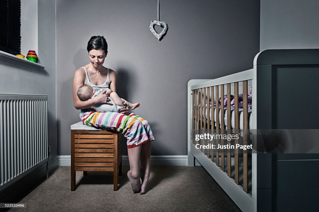 Mother cradling baby