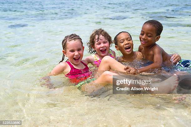 children playing at beach, jamaica - jamaica beach stock pictures, royalty-free photos & images