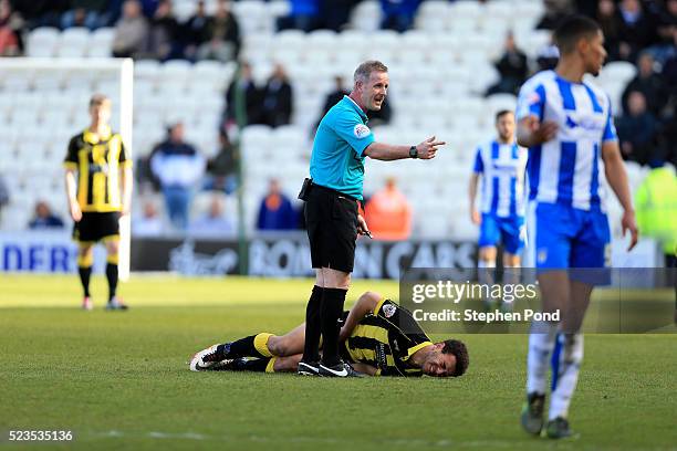 Mason Bennett of Burton Albion reacts prior to leaving the field on a stretcher during the Sky Bet League One match between Colchester United and...