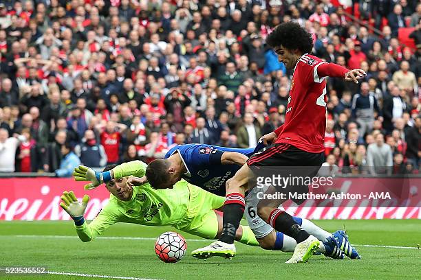 Phil Jagielka of Everton blocks the attempt on goal of Marouane Fellaini of Manchester United during the Emirates FA Cup Semi Final match between...