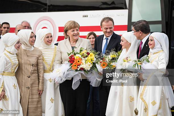 In this photo provided by the German Government Press Office , European Council Donald Tusk, Turkey's Prime Minister, Ahmet Davutoglu and German...