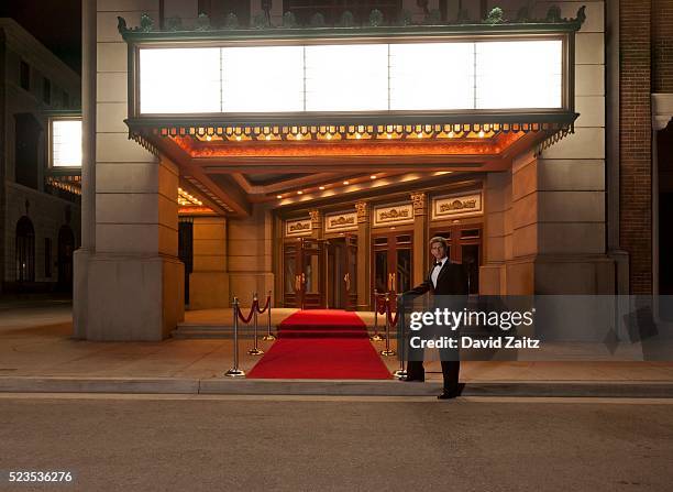 man standing by the red carpet - red carpet foto e immagini stock