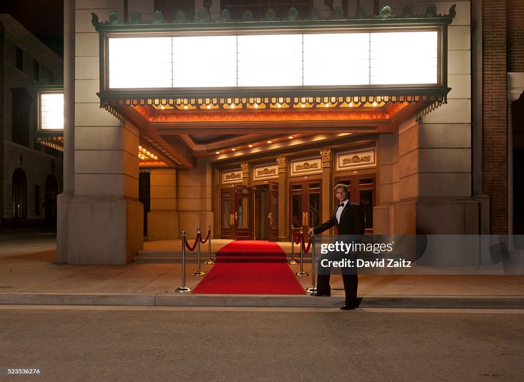 Man standing by the red carpet