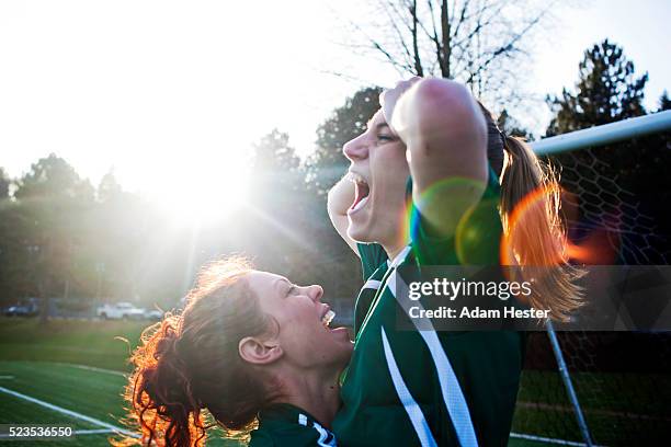 two female friends cheering - strong emotion stock-fotos und bilder