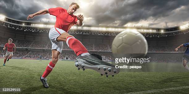 soccer player kicking ball - kicking soccer stock pictures, royalty-free photos & images