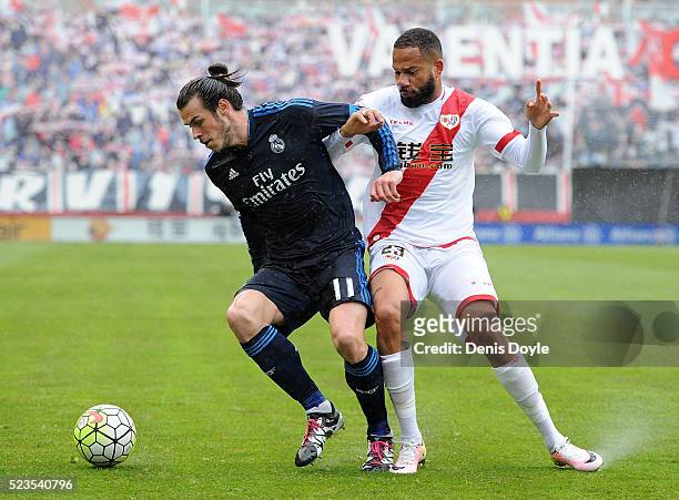 Gareth Bale of Real Madrid fends off Tiago Manuel Dias Correia ''Bebe'' of Rayo Vallecano de Madrid during the La Liga match between Rayo Vallecano...