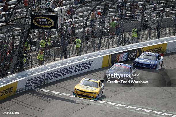 Dale Earnhardt Jr., driver of the Hellmann's Chevrolet, takes the checkered flag to win the NASCAR XFINITY Series ToyotaCare 250 at Richmond...