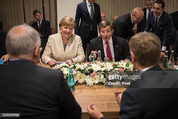 In this photo provided by the German Government Press Office , Turkey's Prime Minister, Ahmet Davutoglu, President of the European Council Donald...
