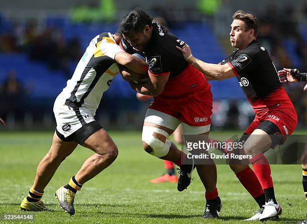 Billy Vunipola of Saracens is tackled by George Smith during the European Rugby Champions Cup semi final match between Saracens and Wasps at Madejski...