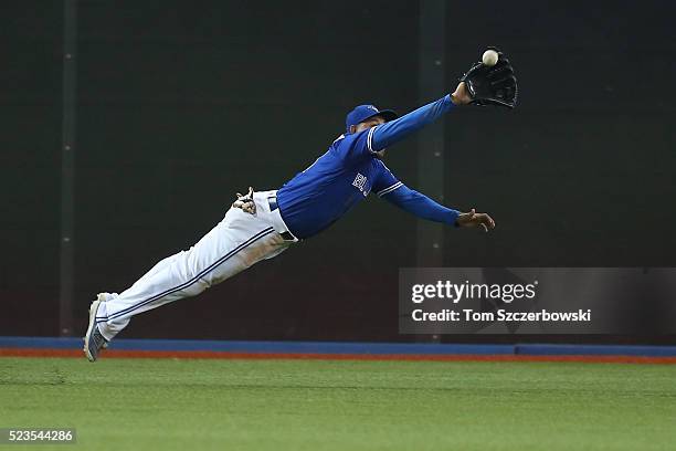 Ezequiel Carrera of the Toronto Blue Jays makes a diving catch in the ninth inning during MLB game action against the Oakland Athletics on April 23,...