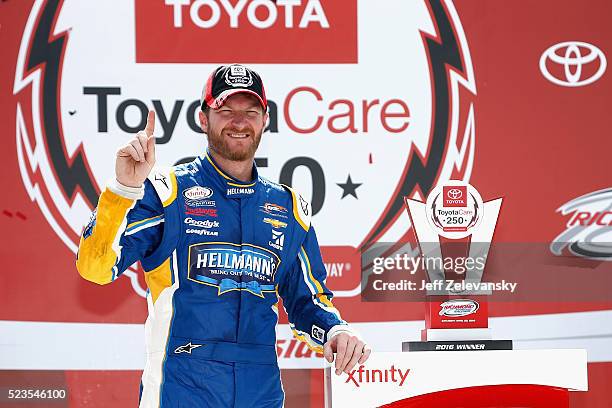 Dale Earnhardt Jr., driver of the Hellmann's Chevrolet, poses for a photo in Victory Lane after winning the NASCAR XFINITY Series ToyotaCare 250 at...