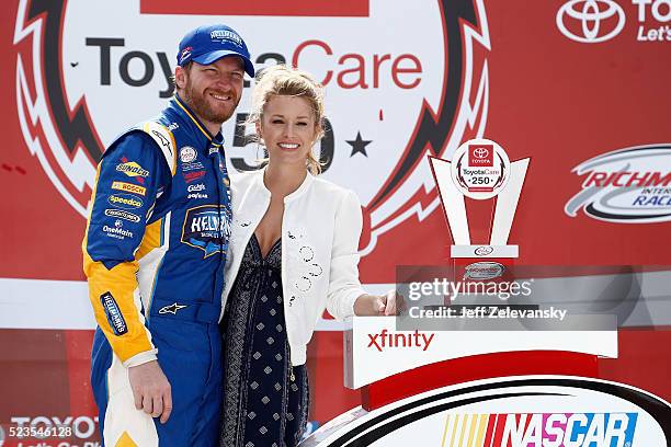 Dale Earnhardt Jr., driver of the Hellmann's Chevrolet, poses for a photo with his girlfriend Amy Reimann in Victory Lane after winning the NASCAR...